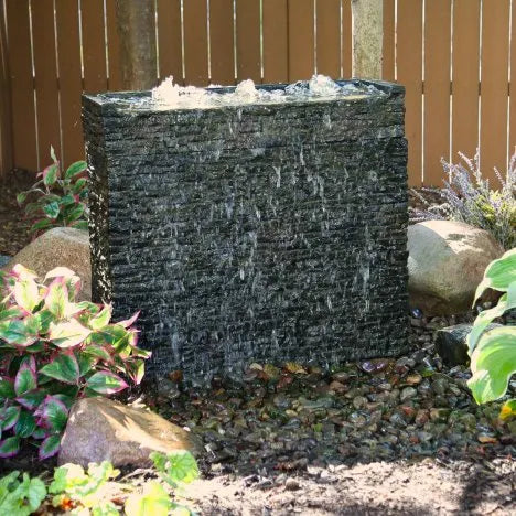 Stacked Slate Wall Base 26″ in use with topper and water cascading over textured stone surface.