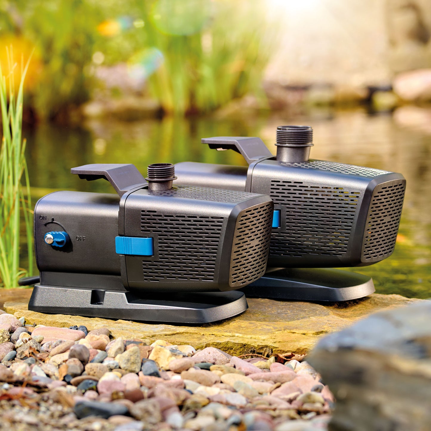 OASE Aquarius Eco Premium fountain pump series beside a pond