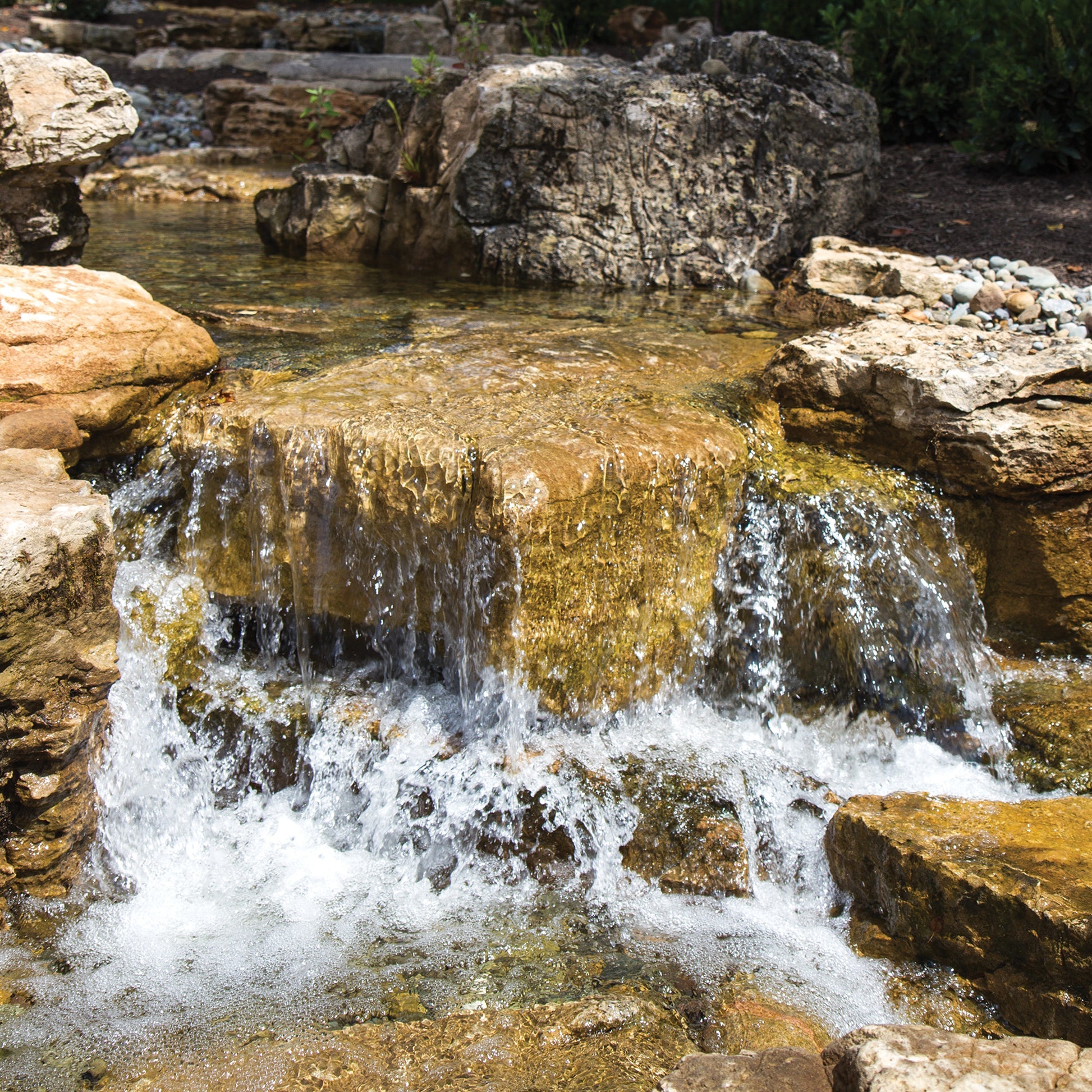Small waterfall flowing over rocks in a natural setting