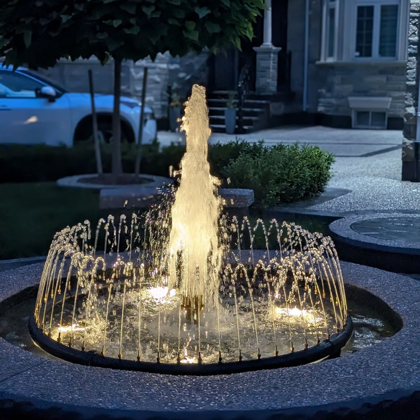 Decorative water fountain with lights in a garden setting