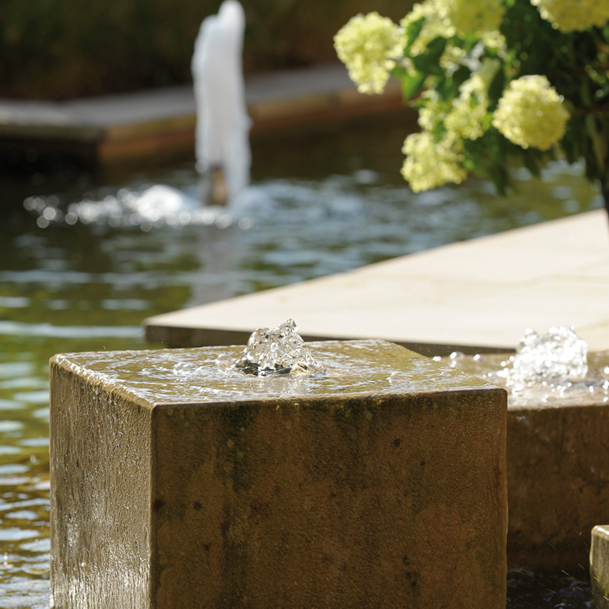 OASE fountain pump operating in a garden water feature